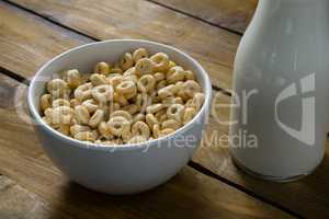 Cereal rings and milk on wooden table