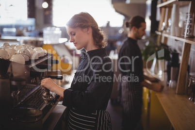 Side view of young baristas