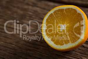 Halved orange on wooden table