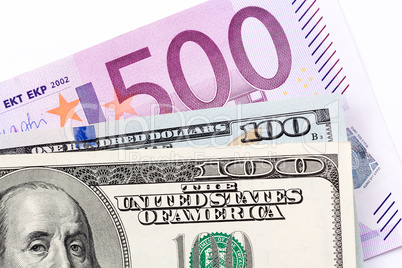 Close up of euros and dollars on white background.
