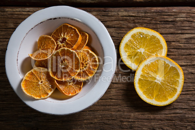 Dried and sliced sweet lemon on wooden table