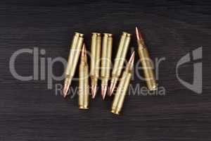 Old ammunition on the wood background. Army equipment.