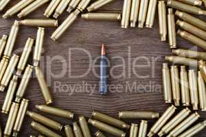 Ak-47 cartridges on wooden table close-up.