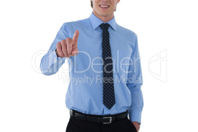 Mid section of smiling businessman using interface while standing with hand in pocket