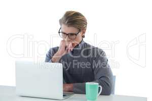 Businessman using laptop computer at table
