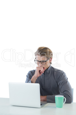 Businessman using laptop at table