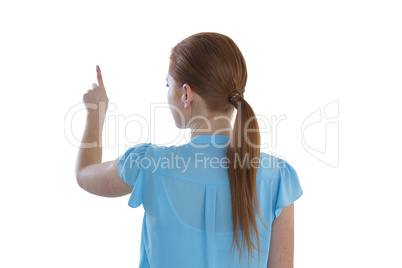 Rear view of businesswoman touching imaginary screen