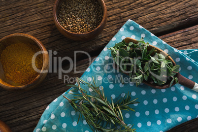 Various spices with herbs on wooden table