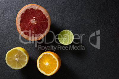 Halved citrus on black background