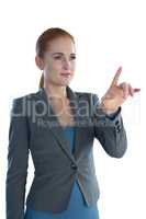 Young businesswoman using imaginary interface