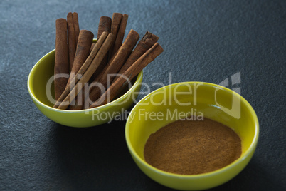 Cinnamon sticks and powder in a bowl
