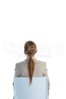 Rear view of businesswoman sitting on chair
