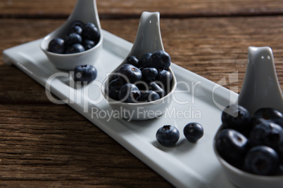 Blueberries in spoon arranged on tray