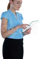 Smiling businesswoman using glass interface against white background