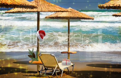 Christmas beach: a deck chair and a Santa Claus hat.