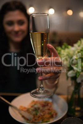 Woman having champagne while dining