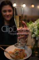 Woman having champagne while dining