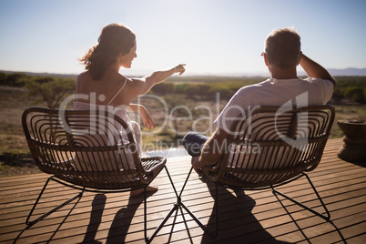 Senior couple sitting on chairs at the resort