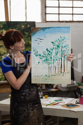 Beautiful woman holding her painting