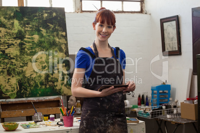 Portrait of beautiful woman holding digital tablet