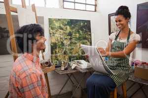 Woman drawing a portrait of man in drawing book