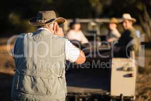 Man taking a picture of his friends during safari vacation