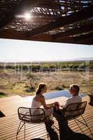 Senior couple sitting on chairs at the resort