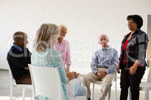 Woman talking to friends sitting on chair