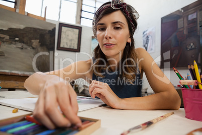 Woman drawing on book in drawing class