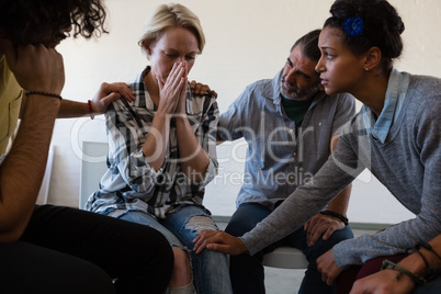 Friends consoling worried female