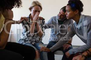 Friends consoling worried female