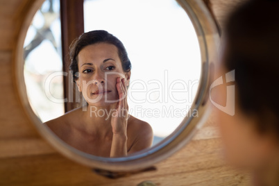 Woman looking at mirror in cottage