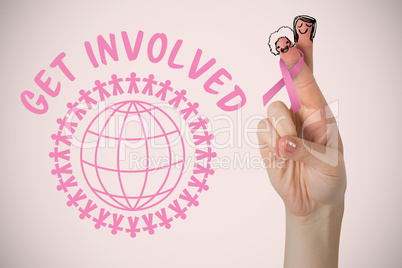 Composite image of cropped hand with breast cancer awareness ribbon