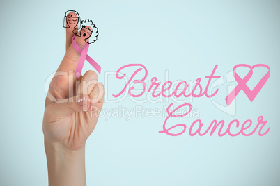 Composite image of breast cancer awareness ribbon on cropped hand of woman