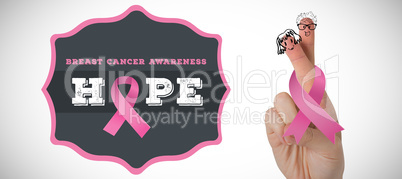 Composite image of cropped hand with breast cancer awareness ribbon