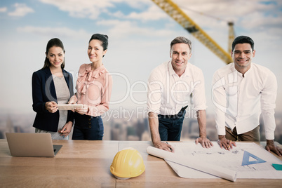 Composite image of portrait of architects at table