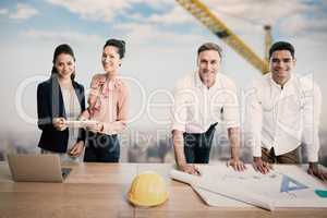 Composite image of portrait of architects at table