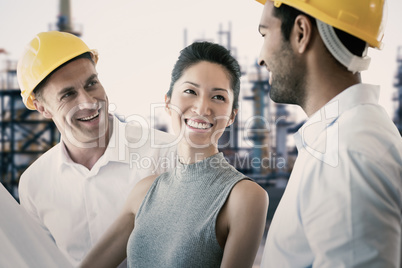 Composite image of happy architect discussing over blueprint