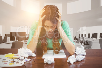 Composite image of frustrated businesswoman sitting against white background