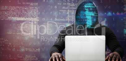 Composite image of male hacker with laptop on table