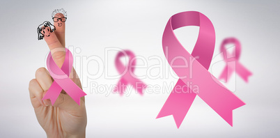 Composite image of cropped hand with breast cancer awareness ribbon