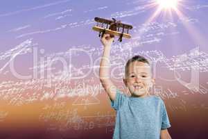 Composite image of portrait of boy holding toy airplane