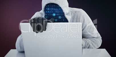 Composite image of hiker in gray hoodie and gloves using laptop