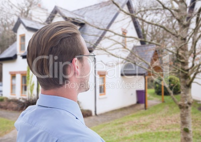 Auctioneer man outside house