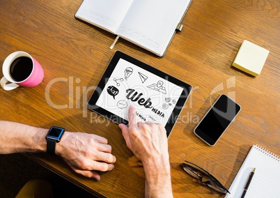 Table top with a tablet with web graphics on the screen