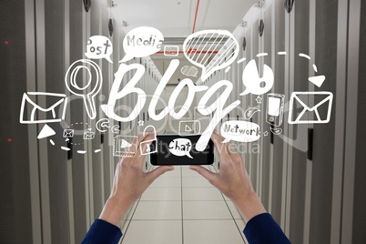 Business woman holding a phone and graphics in server room