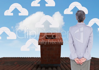 Cloud upload icons and Businesswoman standing on Roof with chimney and blue sky