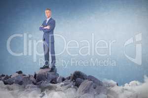 Composite image of businessman standing arms crossed over white background