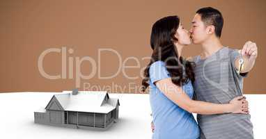 Couple Holding key with house model in front of vignette