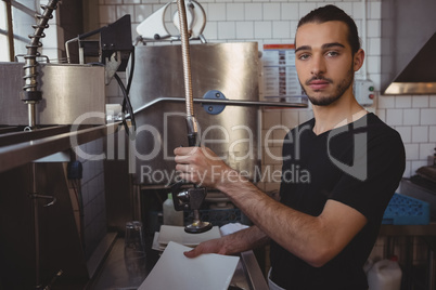 Portrait of waiter washing plate in kitchen